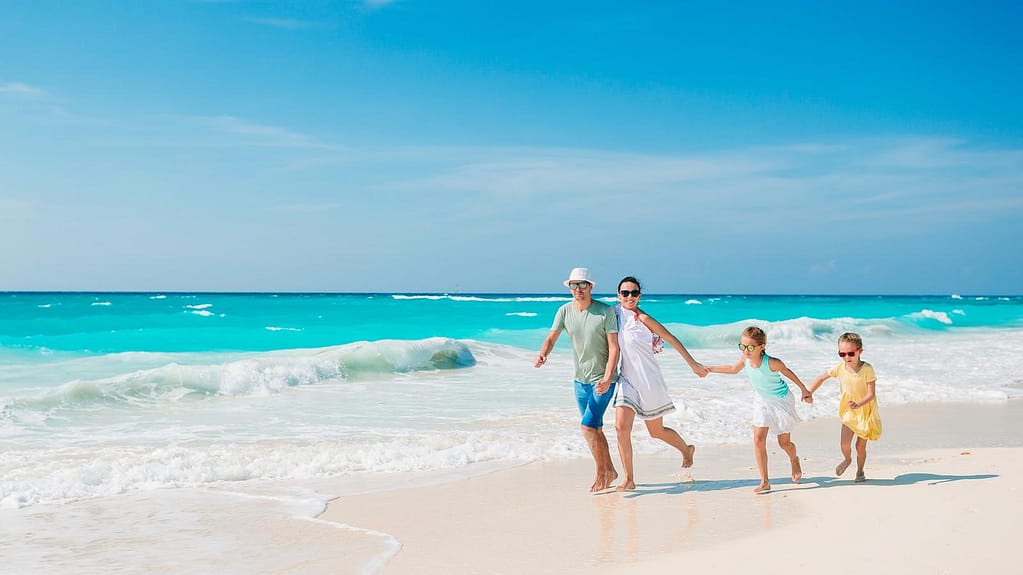 family-beach-resort-vacation-with-kids | Go With The Family family enjoying tropical beach resort vacation with kids by the ocean