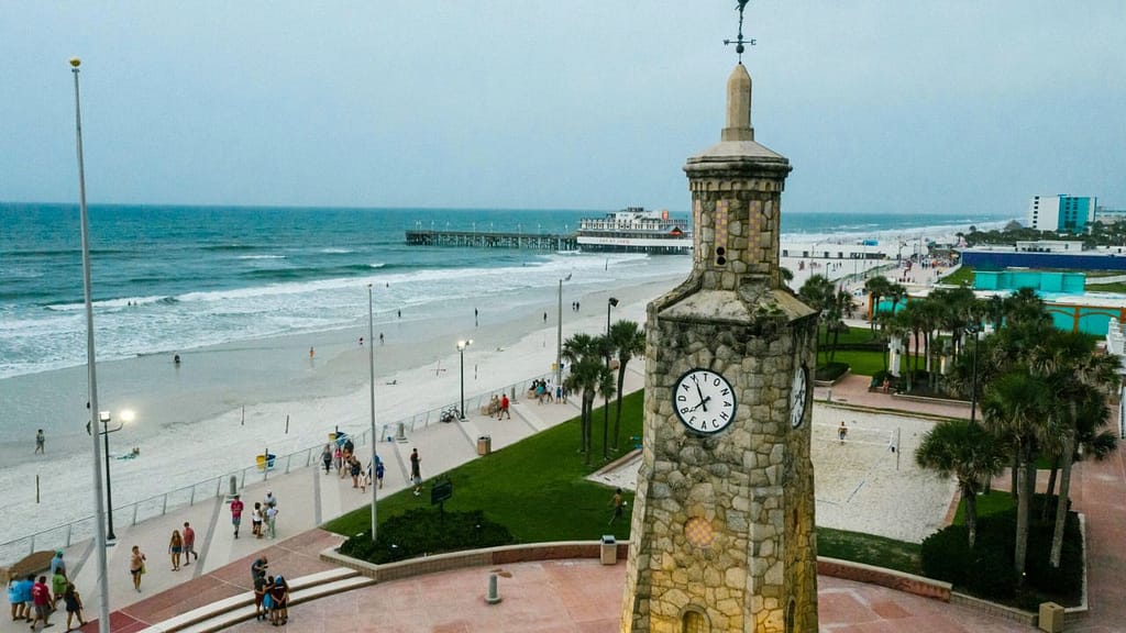 Daytona Beach boardwalk and clock tower on Florida’s Atlantic Coast with waves and wide sandy beach
