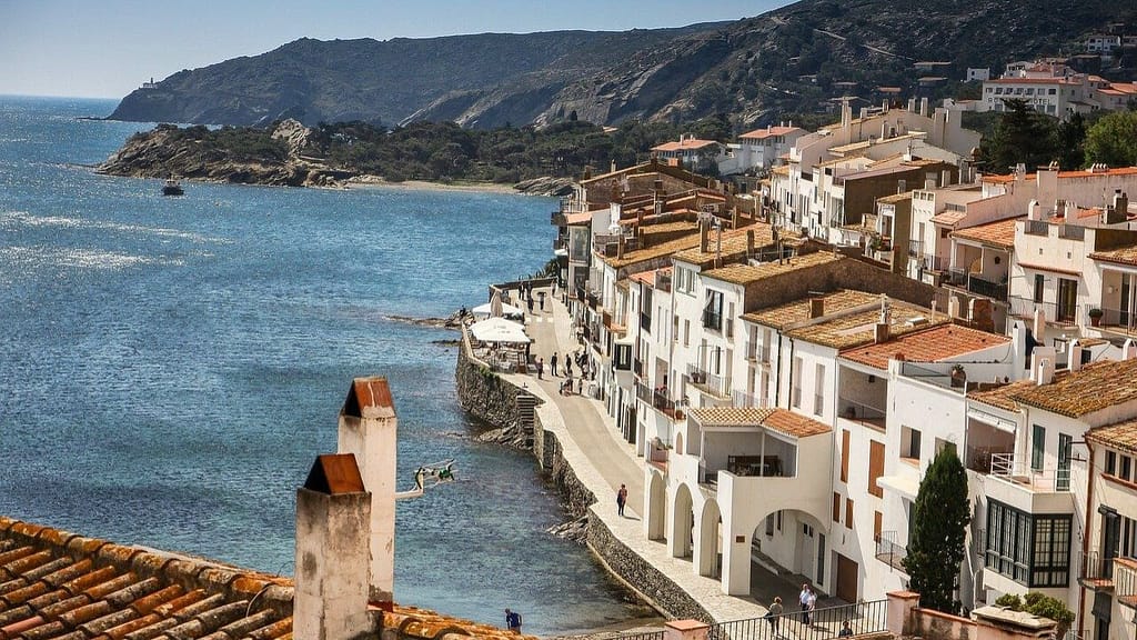 Mediterranean coastal town of Cadaqués in Spain with white buildings and calm blue water