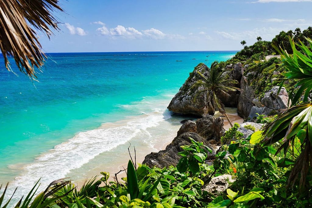 tulum-cliffs-caribbean-coast-mexico-1200x800 | Go With The Family Tulum cliffs overlooking turquoise Caribbean water with jungle vegetation