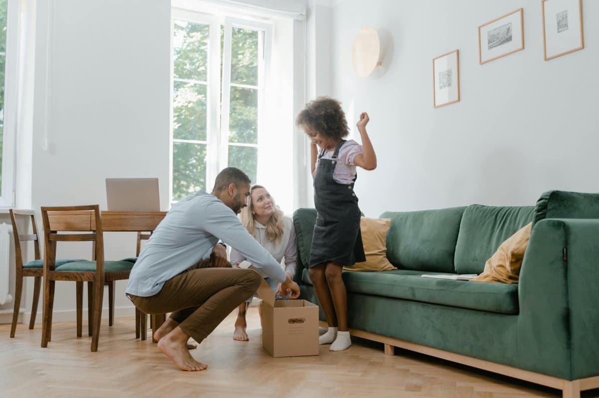 c5927a9a-4e3f-4bc3-9726-18040e5f8be2_1200 | Go With The Family Family sitting together and relaxing in a cozy vacation rental living room