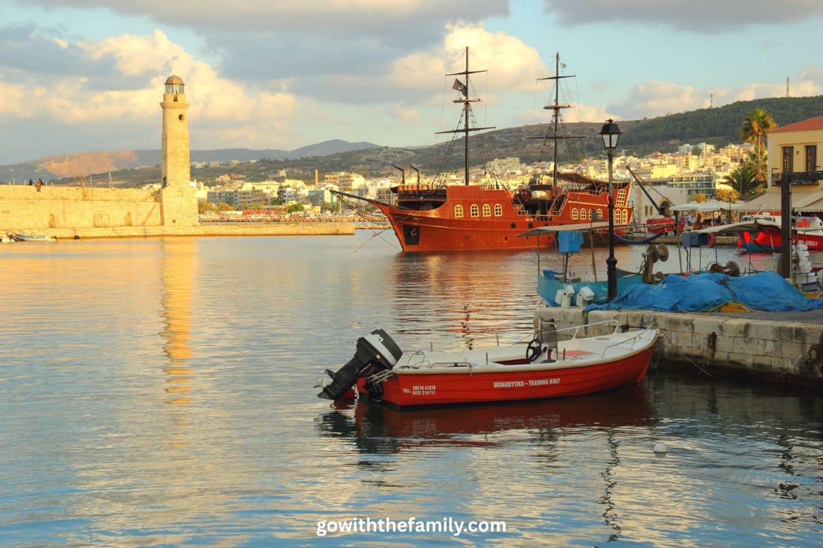 Chania Old Harbor Crete Greece | Go With The Family Chania Old Harbor in Crete, Greece, with historic lighthouse and waterfront promenade.