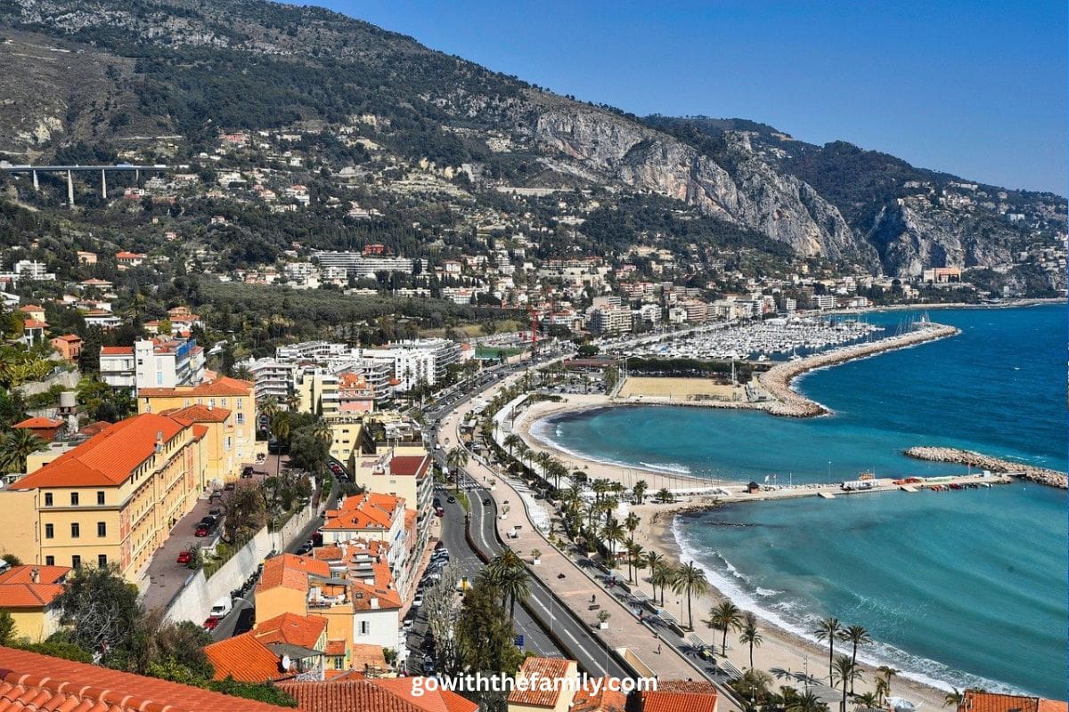 france-family-beach-trip-planning-menton-coastline | Go With The Family Coastal view of Menton on the French Riviera with turquoise water and seaside promenade