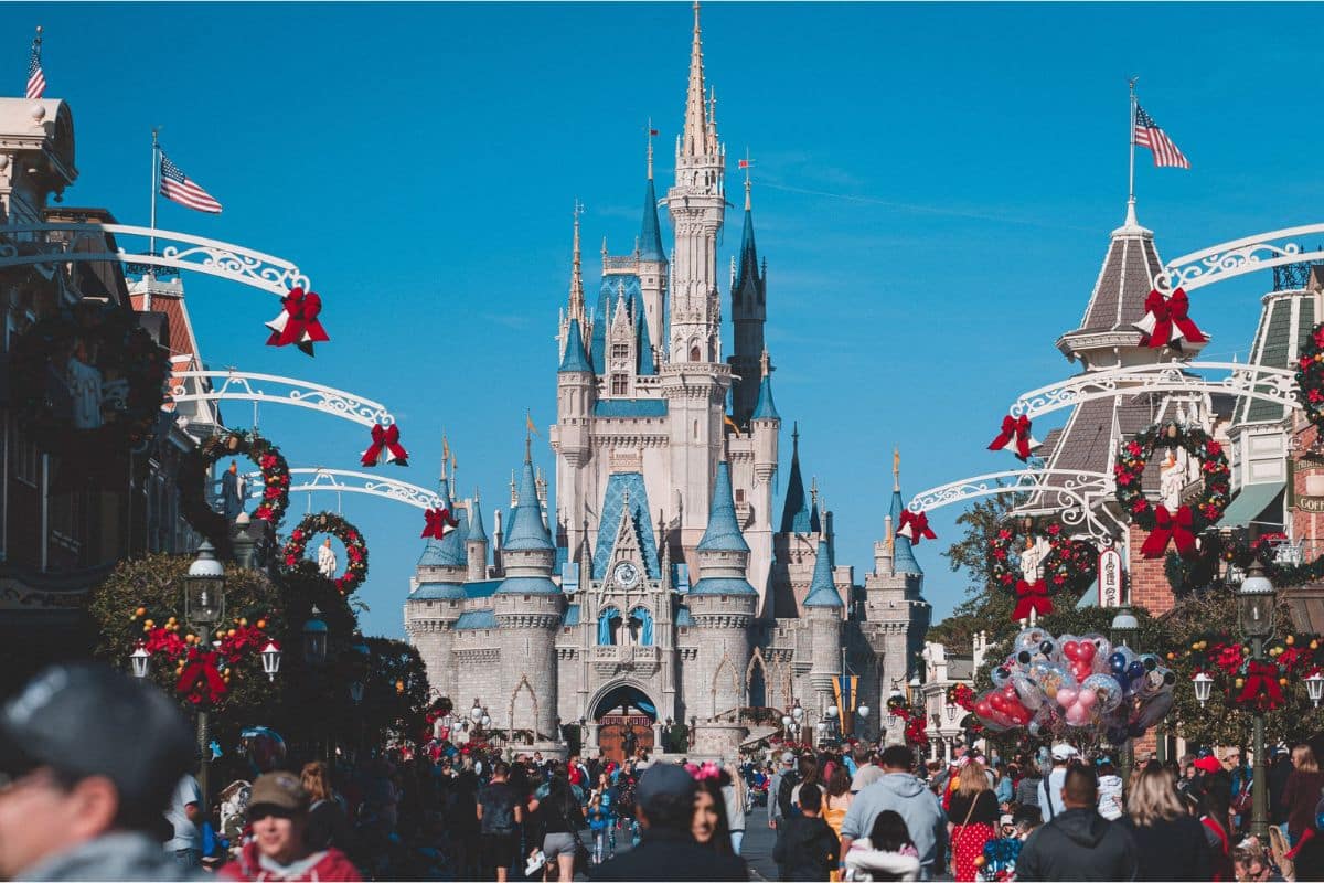 magic-kingdom-main-street-cinderella-castle | Go With The Family Family walking toward Cinderella Castle at Magic Kingdom, the best Disney park for young children and first-time visitors.