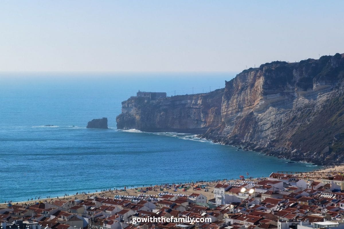 nazare-portugal-family-beach | Go With The Family View of Nazaré beach and cliffs on Portugal's Atlantic coast.