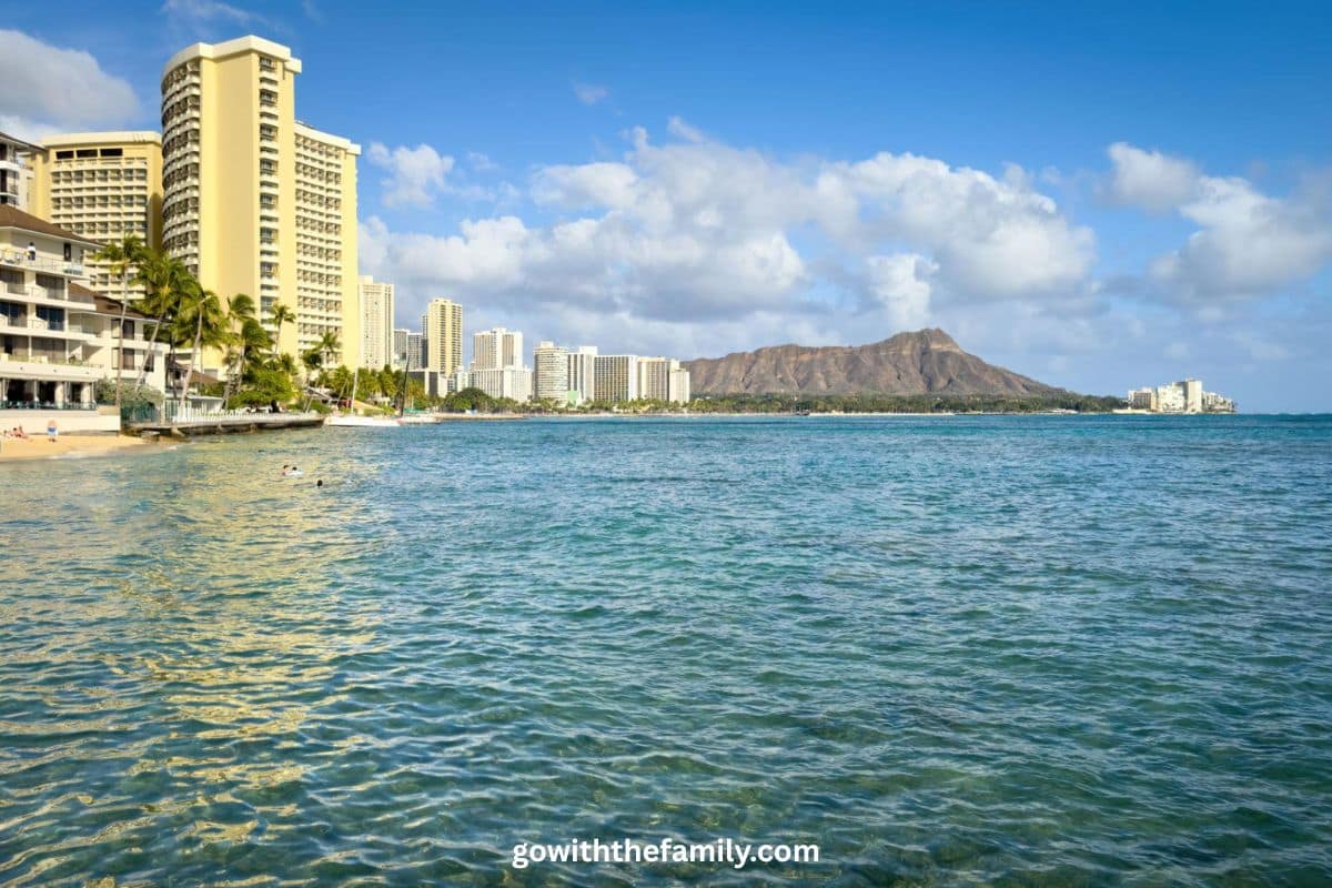 oahu-family-beach-waikiki-hawaii-1200x800 | Go With The Family Family-friendly beach in Oahu Hawaii with turquoise water, palm trees, and tropical coastline