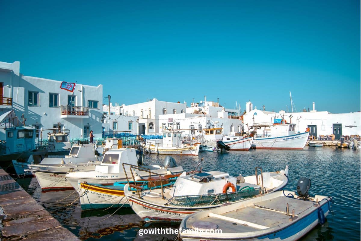 paros-naoussa-harbor-greece. | Go With The Family Traditional harbor in Naoussa Paros Greece with fishing boats and white Cycladic buildings