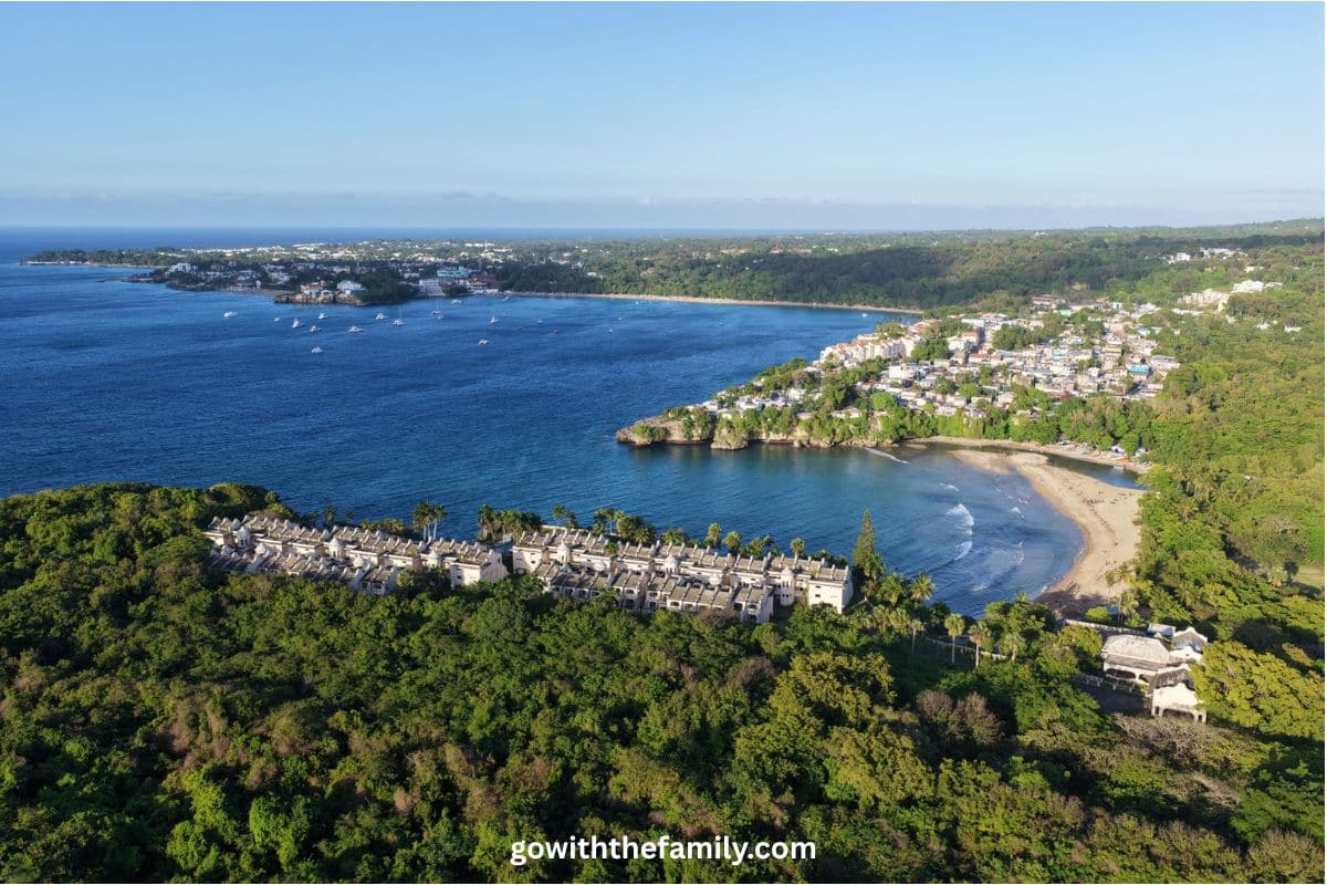 Puerto Plata Family Beach, Dominican Republic | Go With The Family Aerial view of Puerto Plata, Dominican Republic, showing its calm bay, sandy beach, turquoise water, and family-friendly coastline.