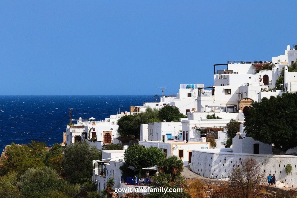 rhodes-greece-family-beach-destination.j | Go With The Family White hillside buildings overlooking the Aegean Sea in Rhodes, Greece