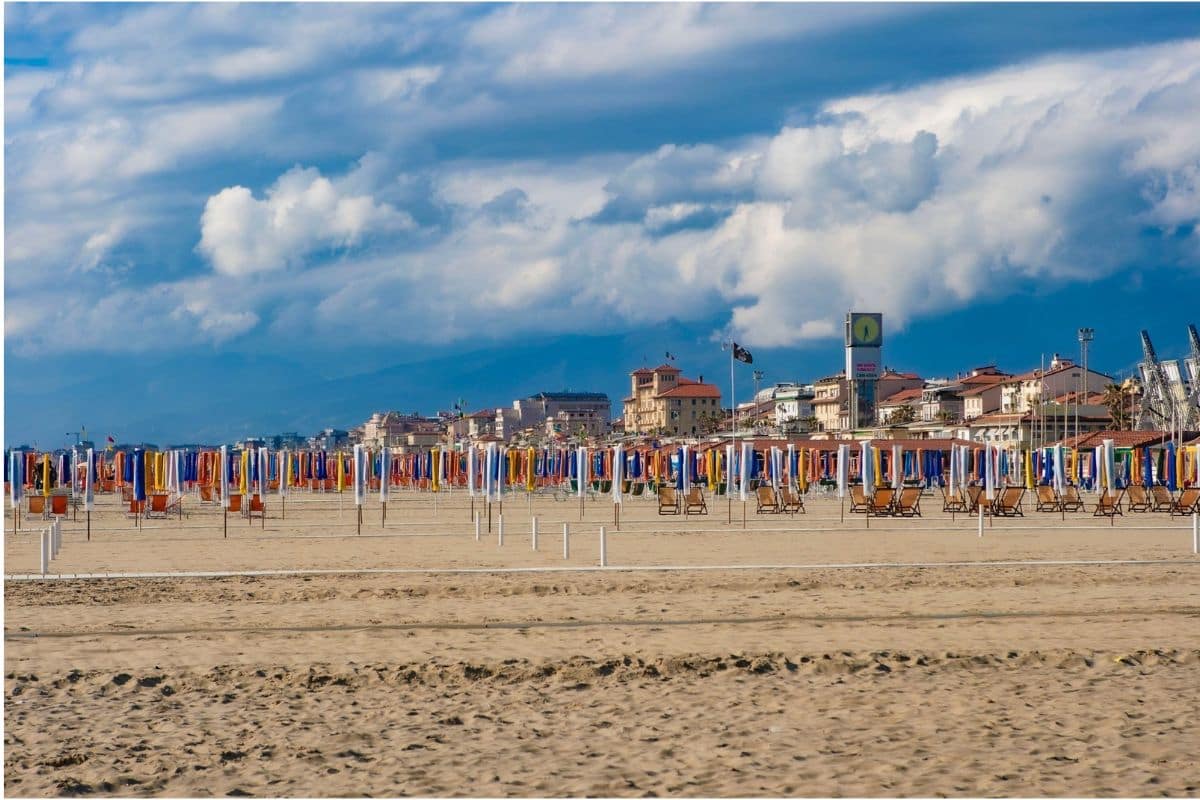 Viareggio Beach, Tuscany, Italy | Go With The Family Sandy Viareggio Beach in Tuscany, Italy, with colourful beach umbrellas and seaside buildings