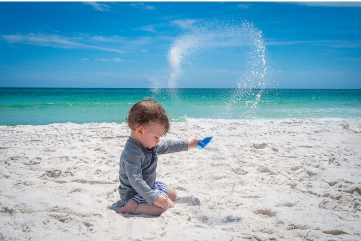 clearwater-beach-family-kids-sand-play-1200x800 | Go With The Family Family with kids playing in the sand at Clearwater Beach Florida with calm shallow water