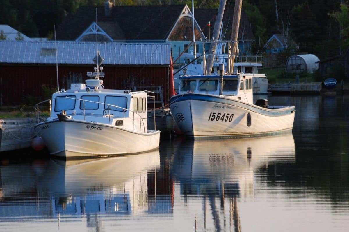 Baddeck Harbour — Cape Breton | Go With The Family Fishing boats in a quiet harbour near Baddeck on Cape Breton Island, Nova Scotia