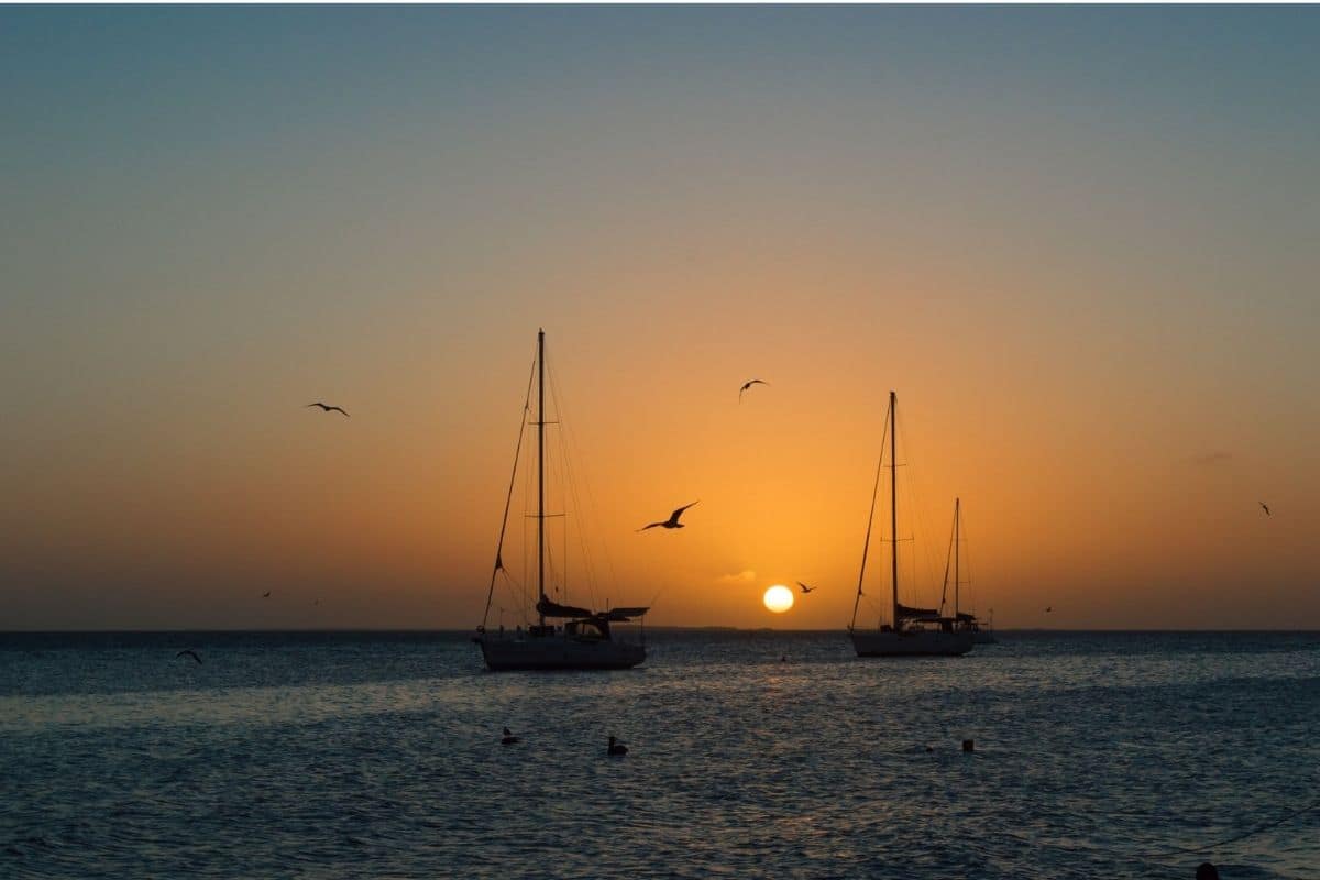 Key West Sunset — Florida Keys | Go With The Family Sailboats silhouetted against a golden sunset over the water in Key West, Florida