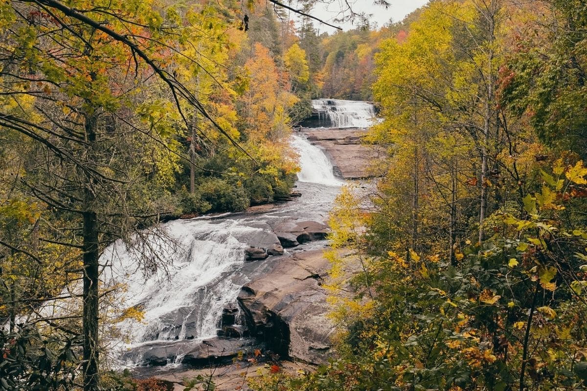 Linville Falls Along the Blue Ridge Parkway | Go With The Family Linville Falls cascading through colorful autumn forest near the Blue Ridge Parkway in North Carolina