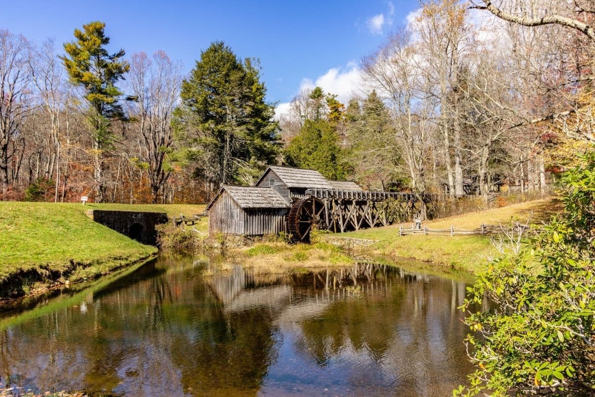Mabry Mill — Blue Ridge Parkway, Virginia | Go With The Family Historic Mabry Mill and waterwheel reflected in the pond along the Blue Ridge Parkway in Virginia