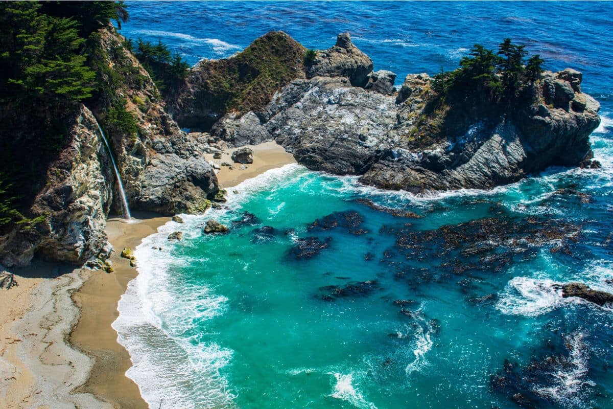 McWay Falls in Big Sur, California | Go With The Family McWay Falls overlooking a turquoise Pacific Ocean cove along the Big Sur coast in California