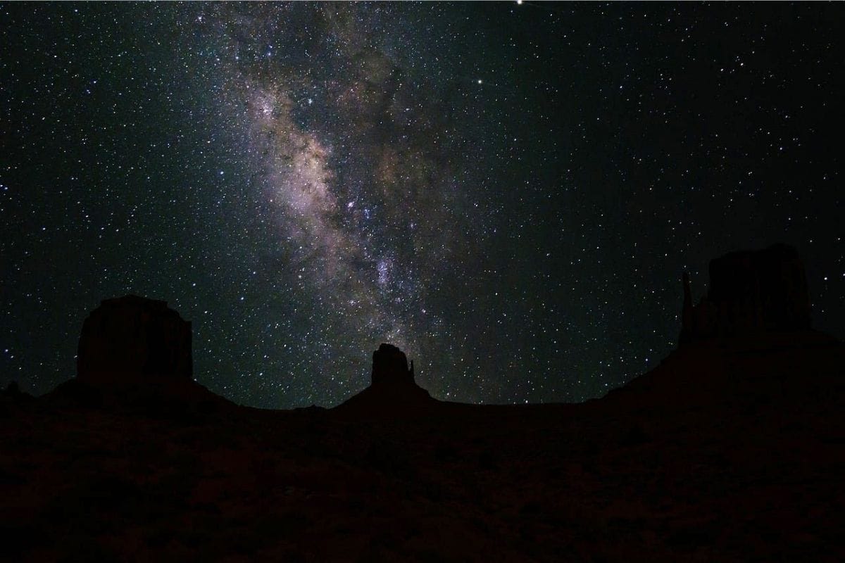Milky Way Over Monument Valley | Go With The Family Milky Way above the dark sandstone buttes of Monument Valley at night