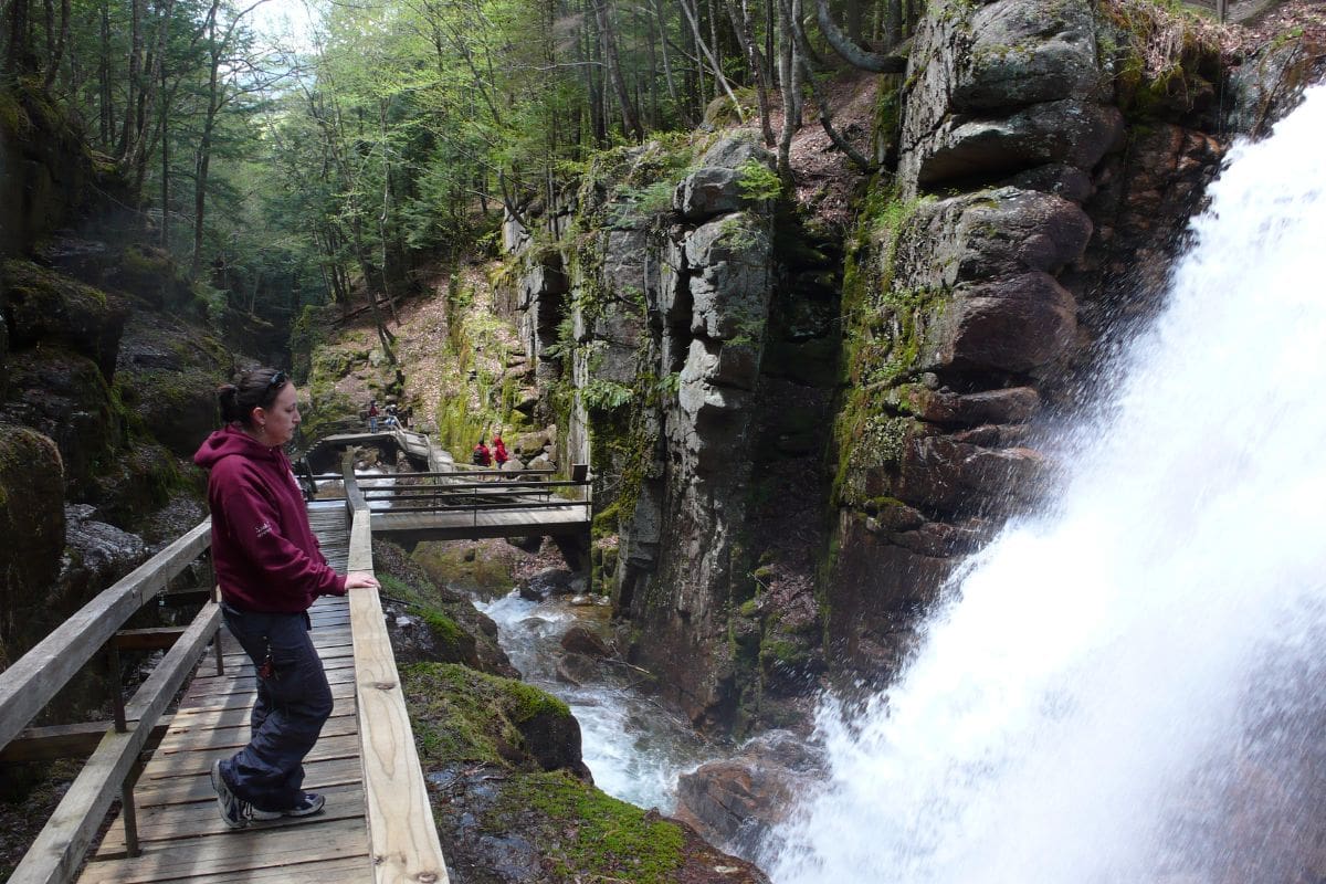 Flume Gorge in Franconia Notch | Go With The Family Wooden boardwalk beside rushing water in Flume Gorge, Franconia Notch, New Hampshire