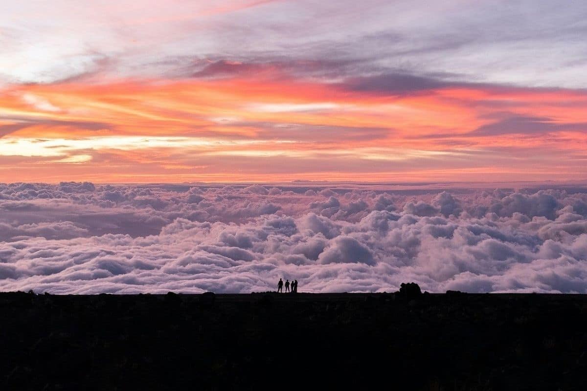 Haleakalā Summit Above the Clouds | Go With The Family Colorful sky above a sea of clouds at the summit of Haleakalā on Maui, Hawaii