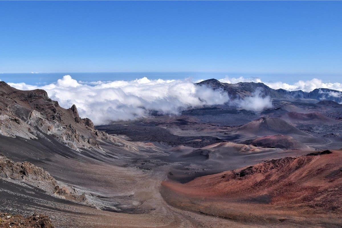 Haleakalā Summit Volcanic Landscape | Go With The Family Volcanic cinder cones and clouds inside the Haleakalā summit landscape on Maui, Hawaii