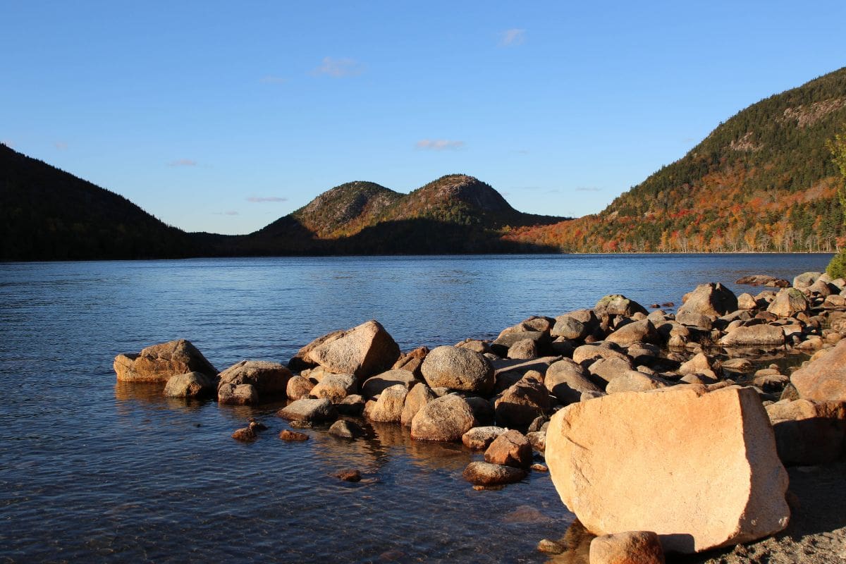 Jordan Pond and the Bubbles in Acadia National Park | Go With The Family Jordan Pond and the Bubbles surrounded by autumn foliage in Acadia National Park, Maine