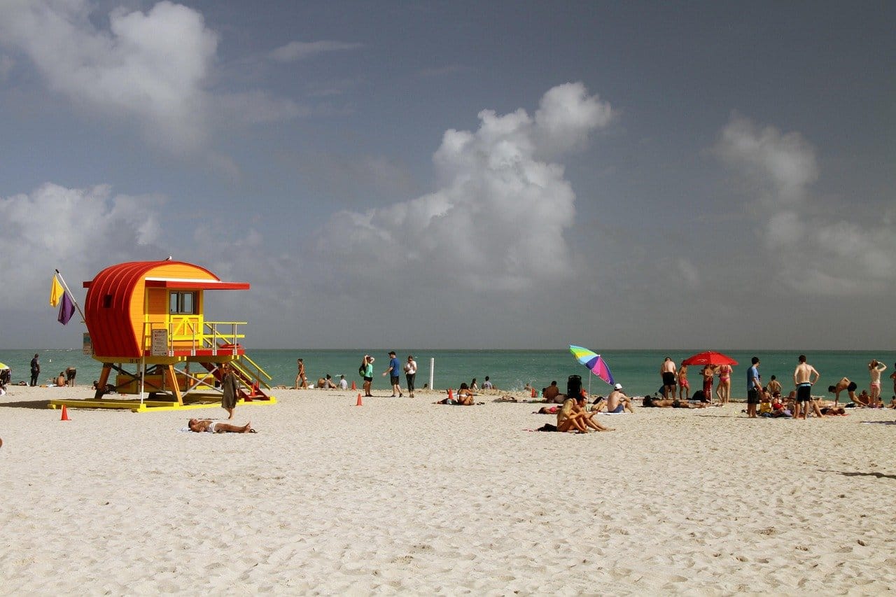 Cocoa-Beach-Florida | Go With The Family Colorful lifeguard tower at Cocoa Beach Florida with families enjoying the beach